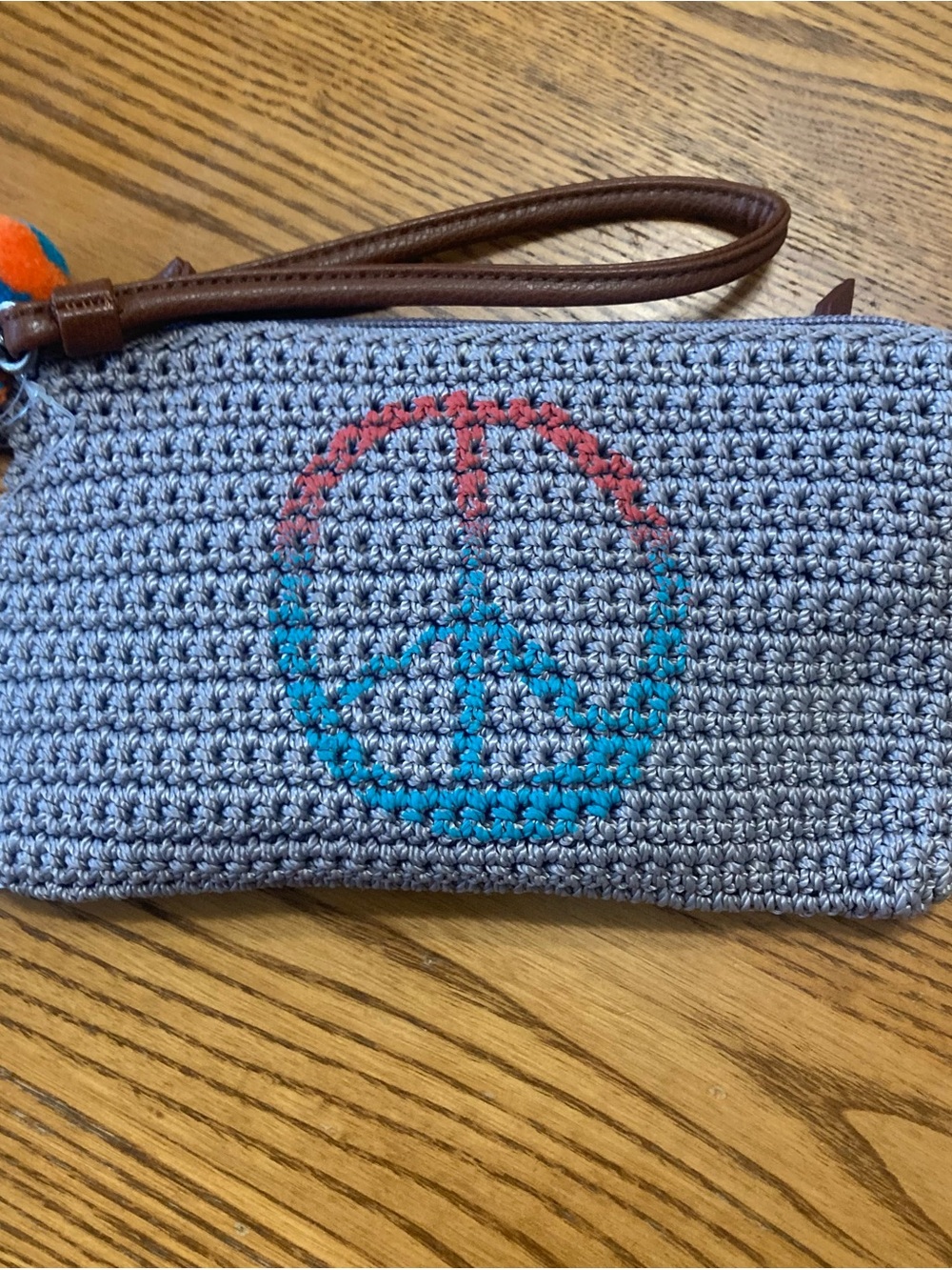 The Sak Gray Crochet Wristlet Clutch with Blue and Coral Peace Sign